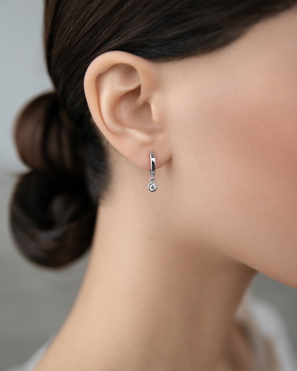 Huggies-earring with a hanging cubic zirconia