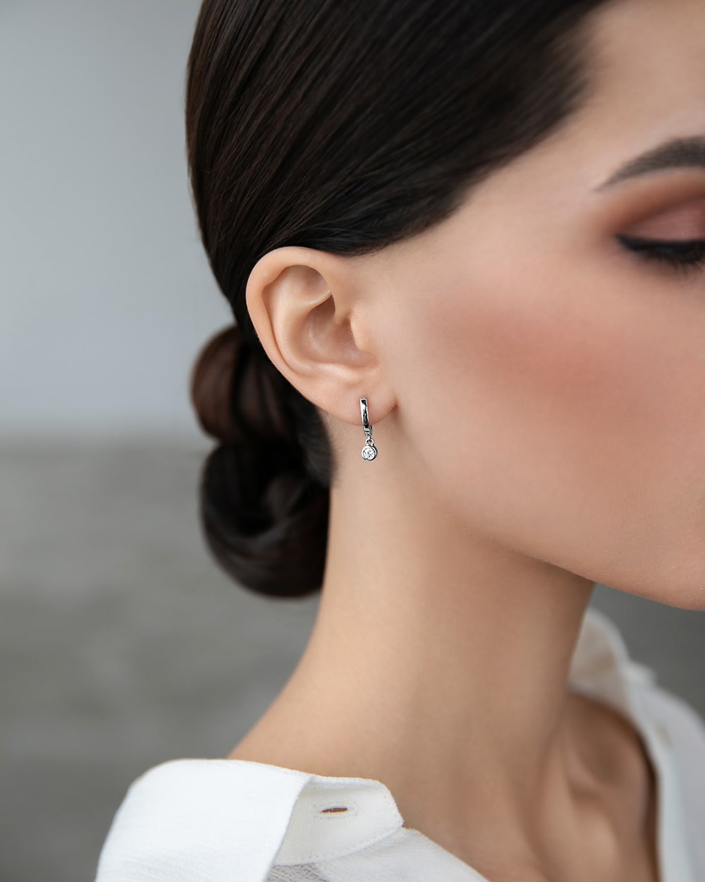 Huggies-earring with a hanging cubic zirconia