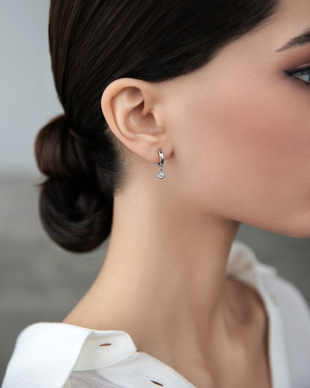 Huggies-earring with a hanging cubic zirconia