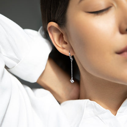 Earrings with a cubic zirconia in a cube
