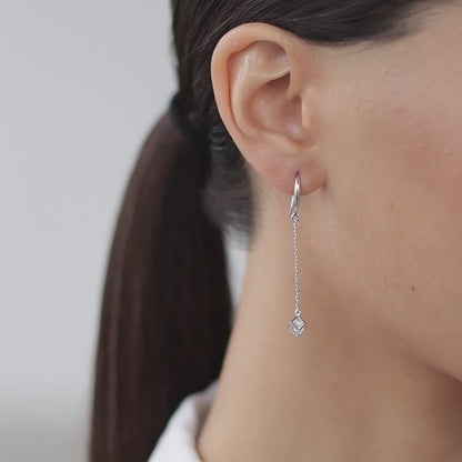 Earrings with a cubic zirconia in a cube